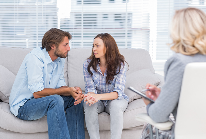 A couple sat together going through a counselling session